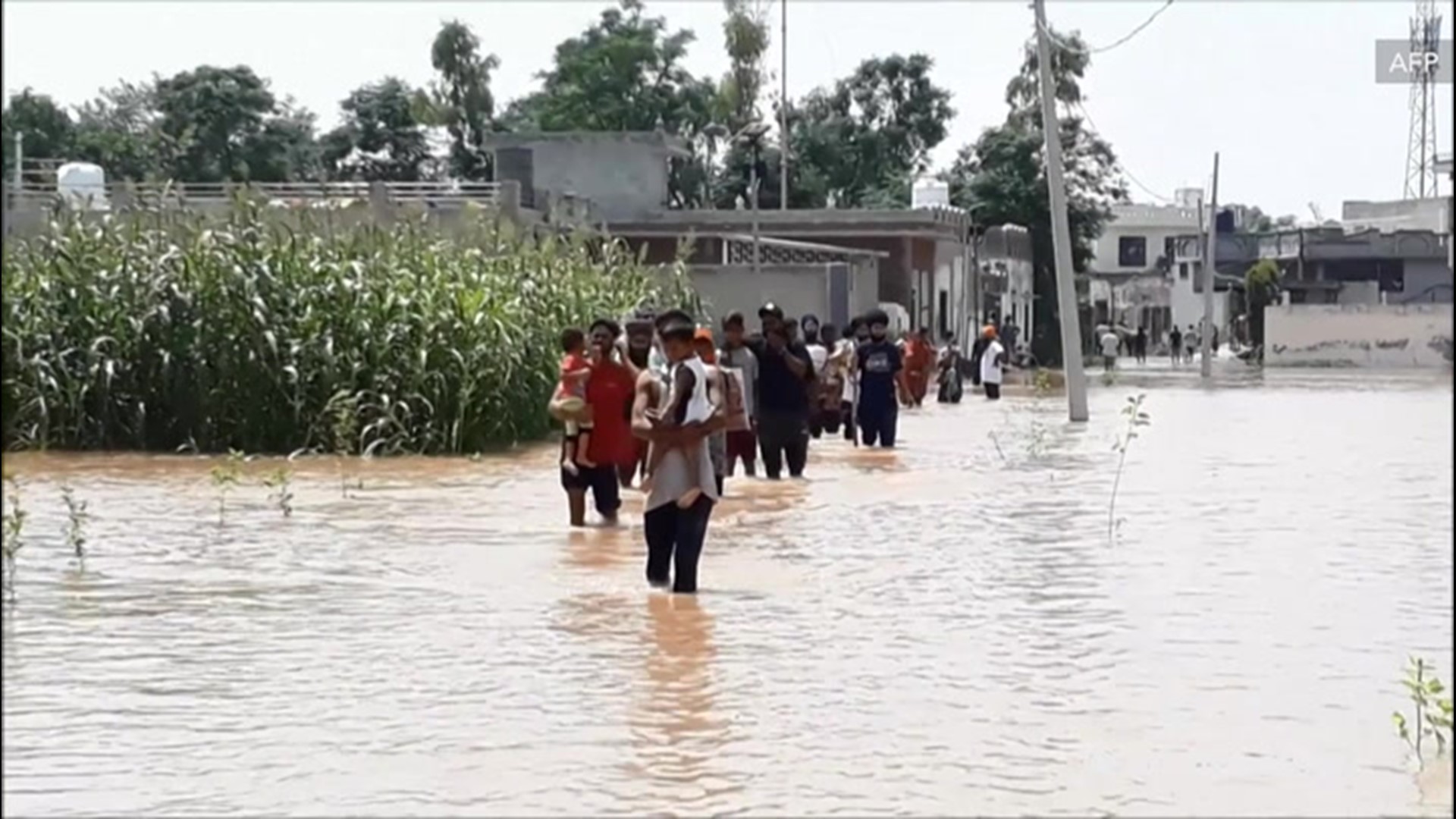 Residents of Kang Khurd village, in northern India, were forced to maneuver through knee-deep water to get around, after flooding ravaged the area on Aug. 20.