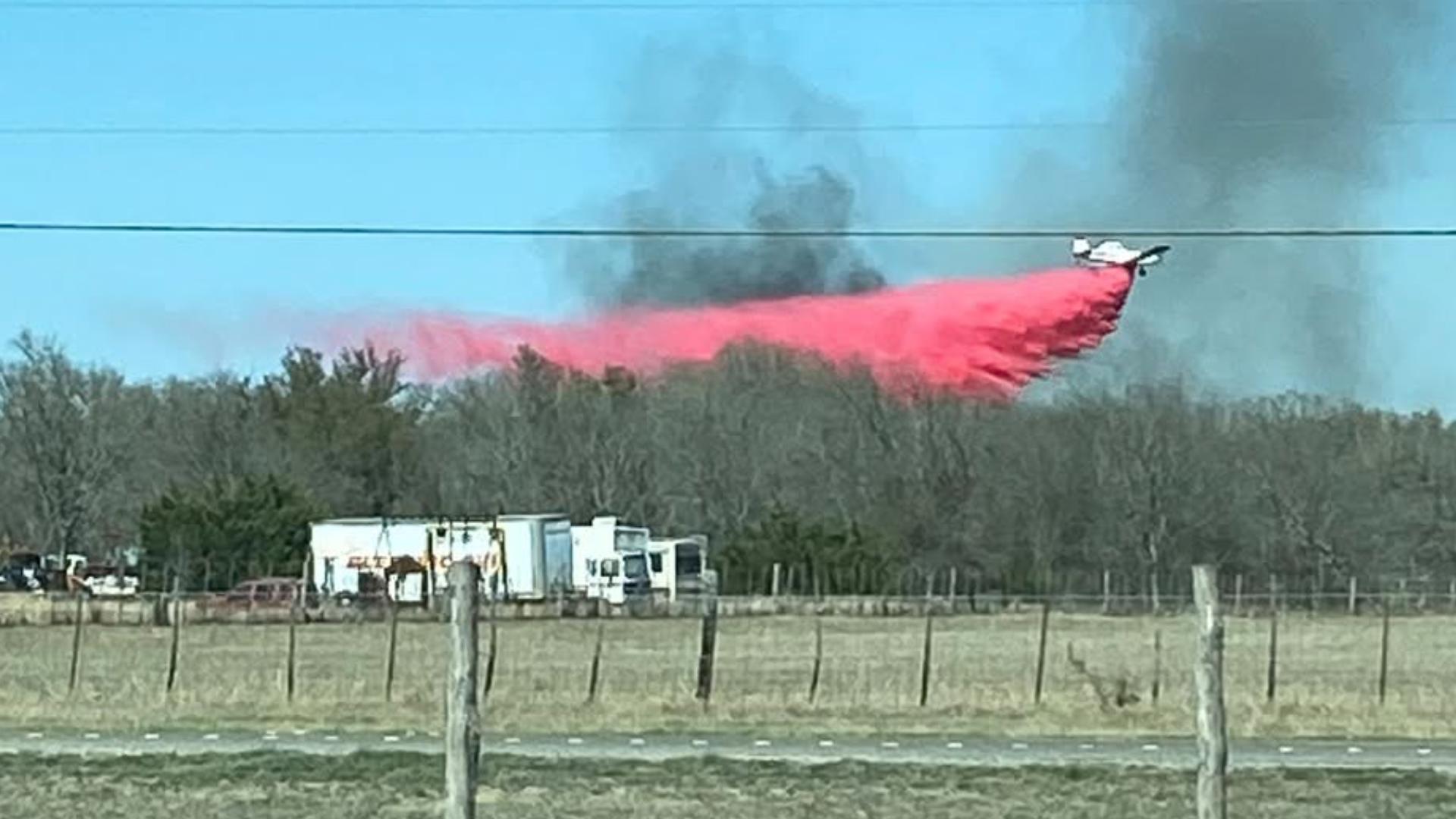 Several fire departments and a firefighting aircraft is currently working to put out a fire that is expanding in Bandera County.