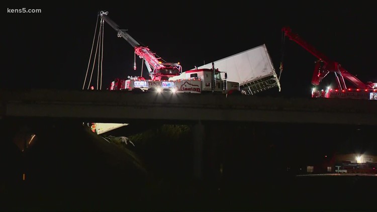 Crews pull 18-wheeler back onto interstate after it was hanging off bridge at New Laredo Highway