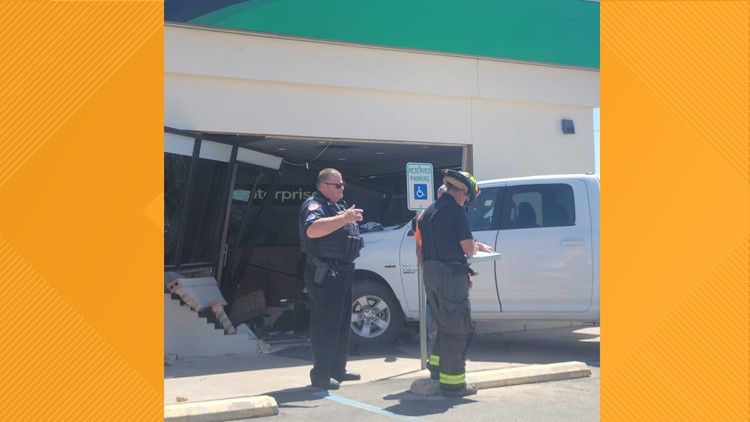 Truck crashes into vehicle rental building, customer injured