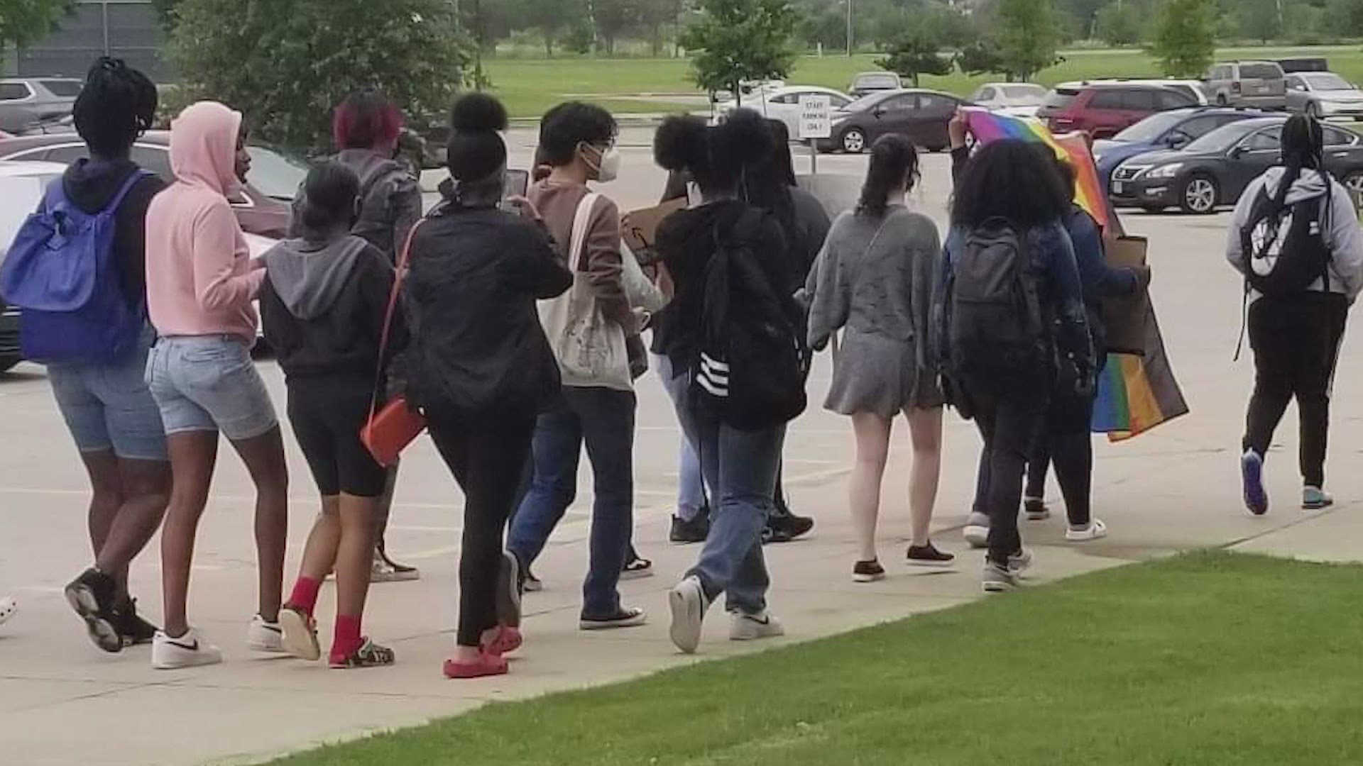 A group of students marched with banners at Horn High School this week. Students say they're protesting disciplinary action taken against a beloved teacher.