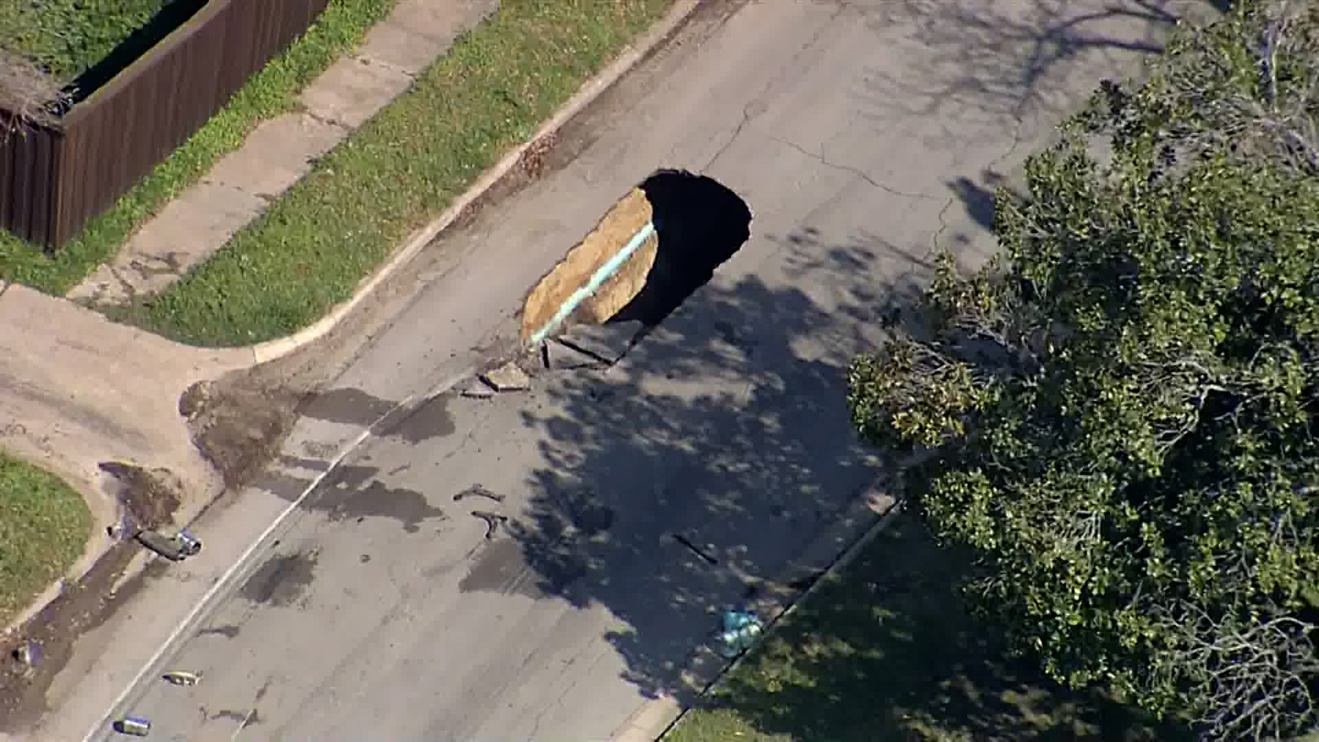 A sinkhole opened on a residential street in Dallas.